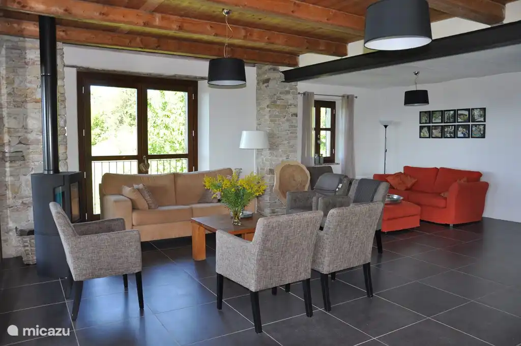 Living Il Monte (first floor) with several seating areas and large sliding doors to a lovely large balcony.