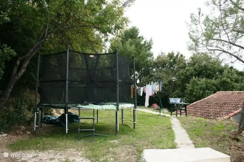 Von der Poolterrasse Sie die Treppe hinunter gehen hinter dem Haus auf dem Trampolin und der Wäscheleine gehen. (Gras auf dem Bild gerade gesät)