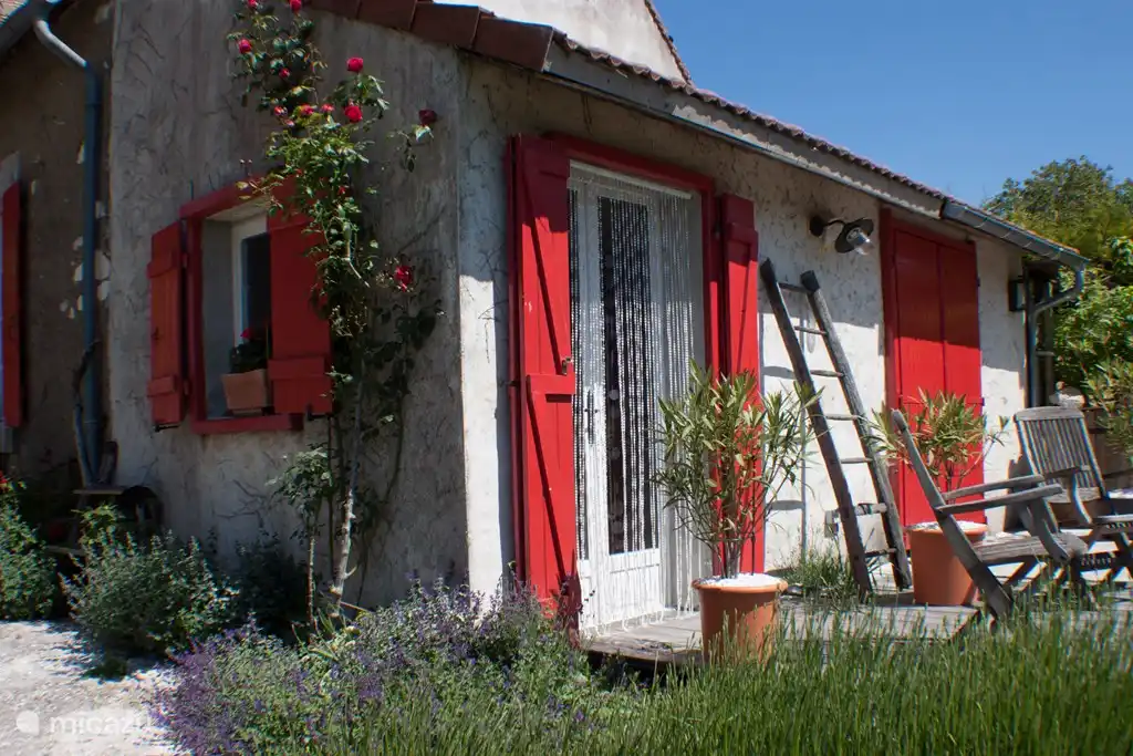 The front and side of the house with lavender and roses