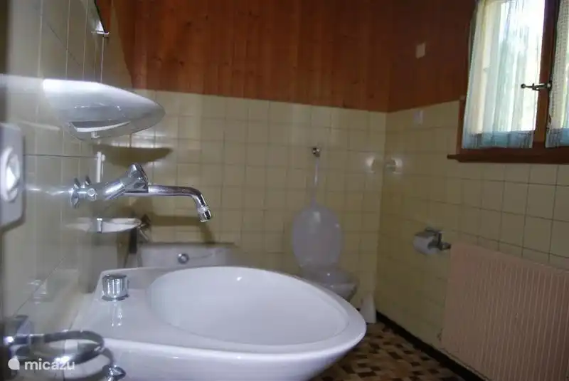 Bathroom with tub and toilet, ground floor.