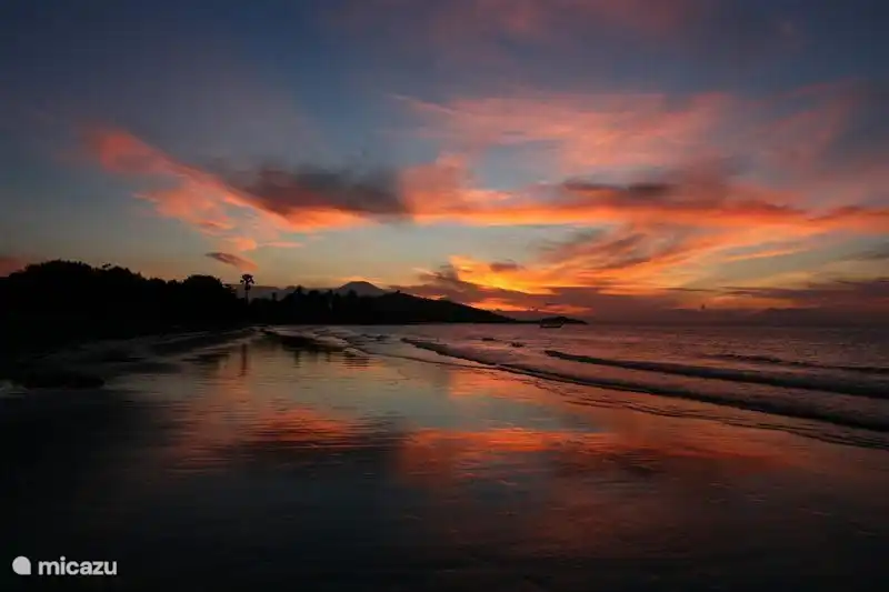 View from the villa, left the sunset behind the volcanoes on Java.