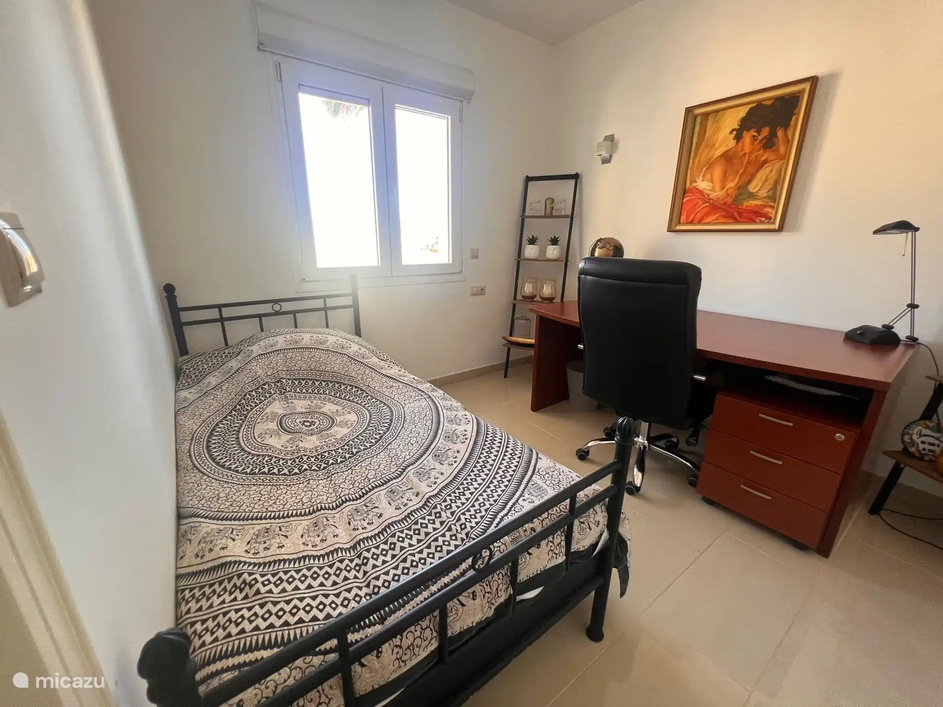 This is one of the bedrooms on the ground floor. This room has an additional desk. 