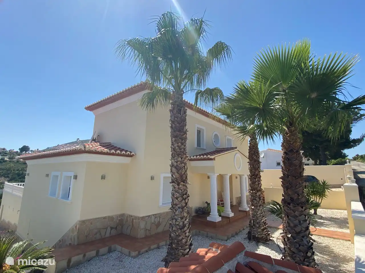 The sun rises in front of the house. 
