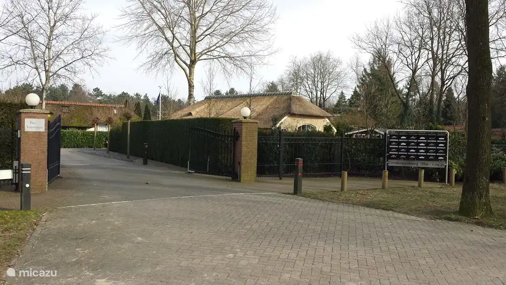 L'entrée du parc. Du coucher au lever du soleil, la porte est fermée et les globes lumineux sont allumés. Vous pouvez ensuite entrer par le grand portail avec la télécommande. À droite de celui-ci se trouve un portillon, qui est toujours ouvert