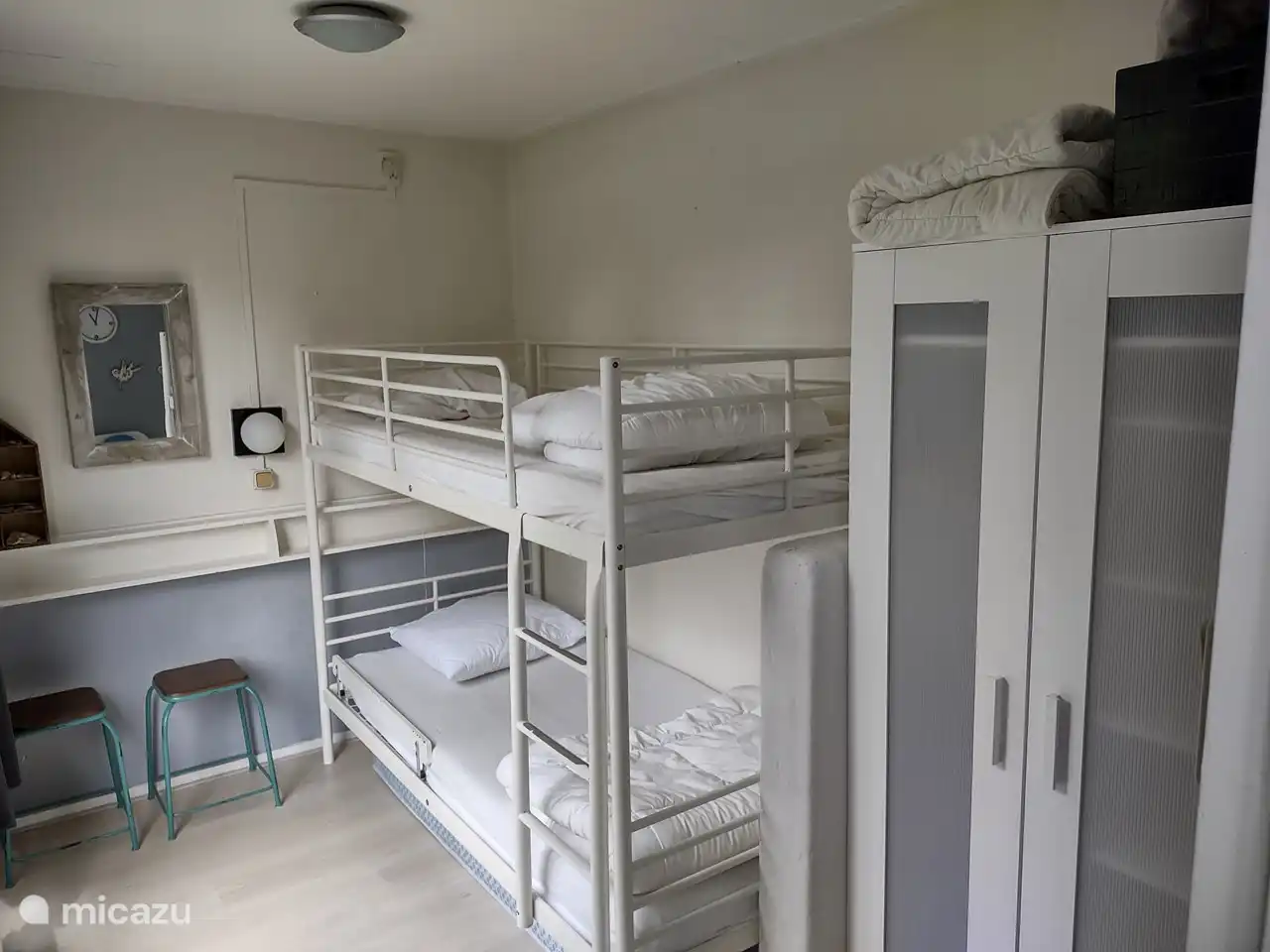 Zweites Schlafzimmer mit Etagenbett (90 x 200) und Zustellbett mit Matratze. Geräumiger Kleiderschrank mit Regalen und Hängebereich.