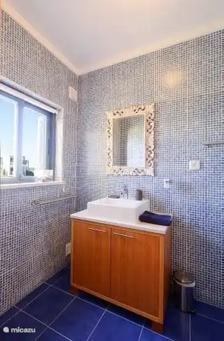 The bathroom in the master bedroom on the ground floor with shower and toilet and sink.