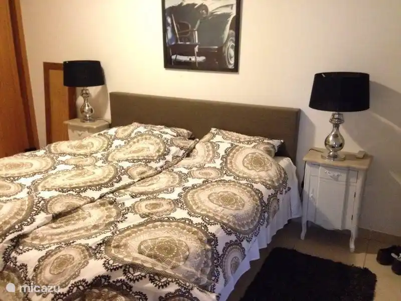 The bedroom on the ground floor, double box spring. Again, a spacious wardrobe present and terrace with electric shutters.