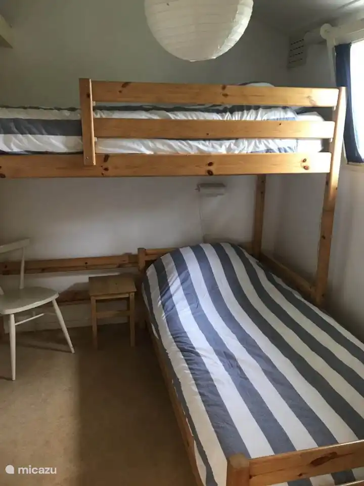 Bedroom with bunk bed in corner arrangement