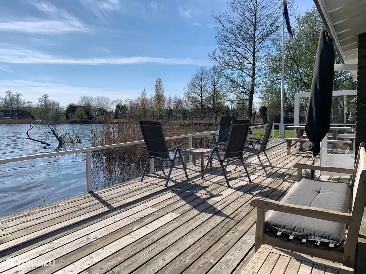 Lovely terrace on the water on the south. Equipped with separate sofa, 6 garden chairs, parasol and dining table with 2 benches