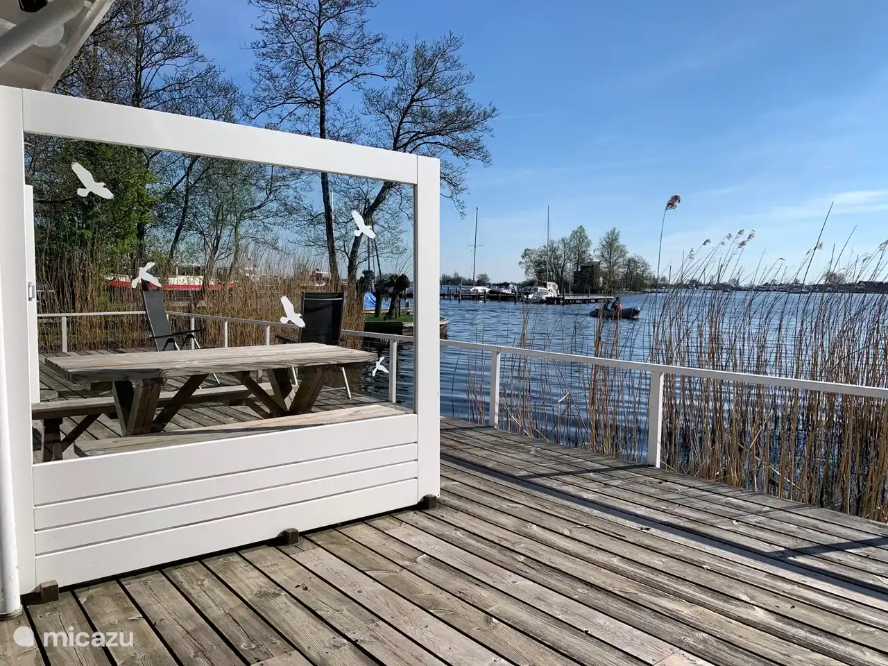 Lovely terrace on the water on the south. Equipped with separate sofa, 6 garden chairs, parasol and dining table with 2 benches