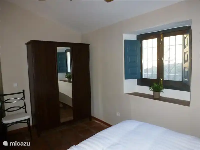 1 bedroom with couches and wardrobe and access to bathroom 1