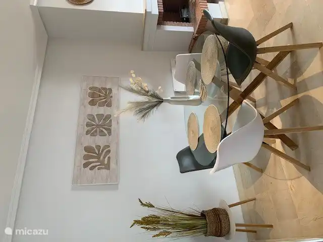 The dining area for 4 people is located in the living room.