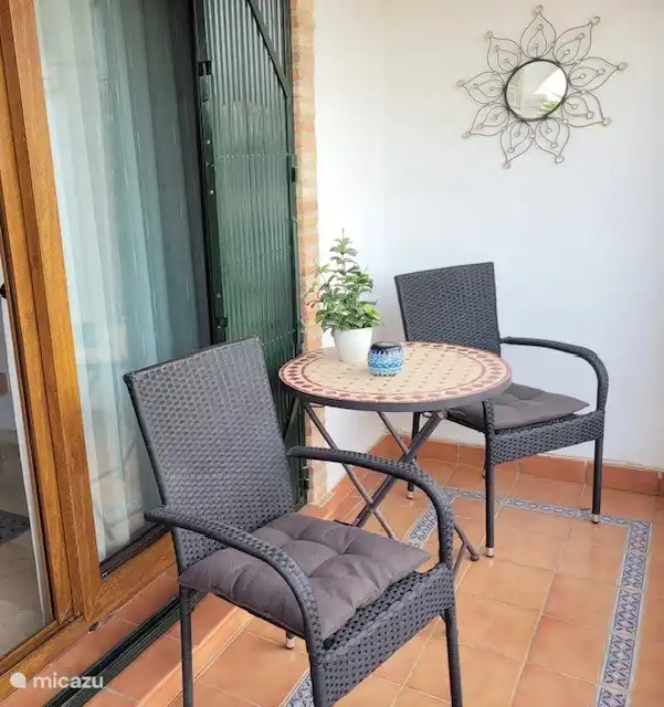 The balcony accessible from the living room overlooking the pool