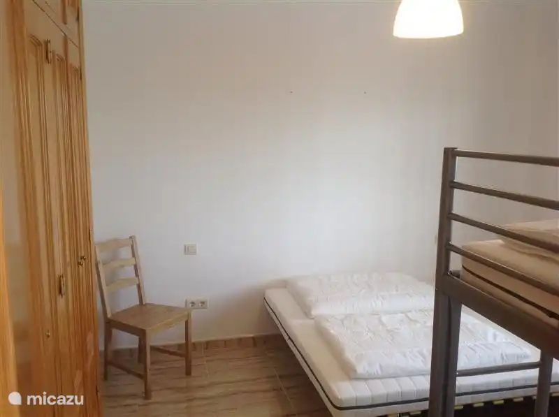 The second bedroom has a double bed of 1.60 plus a bunk bed. Sleeping place for four people in this room.