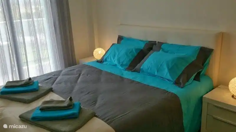 Room with double bed and large wardrobe