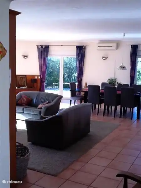 living room, left access to the terraces and the pool and right access to the large kitchen and pantry.