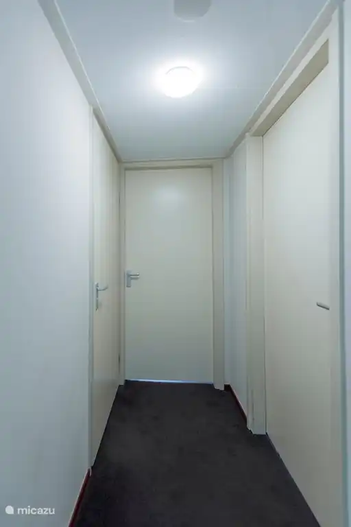 De overloop op de eerste verdieping. Twee slaapkamers en badkamer links