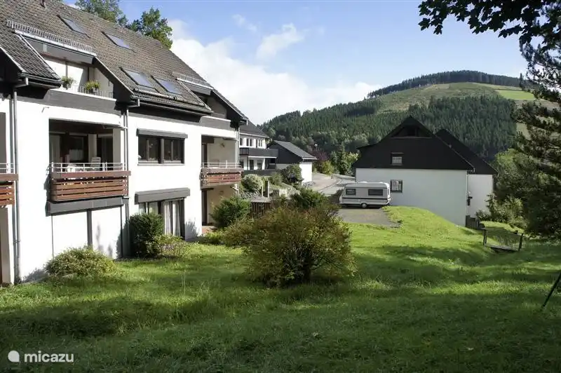 The complex from the garden, through the garden a babbling mountain stream which is a fantastic playground for children