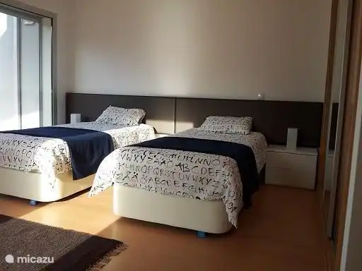 One of the three bedrooms, with patio doors to the balcony / terrace. This bedroom has two single beds, which can, if desired, can slide against each other.