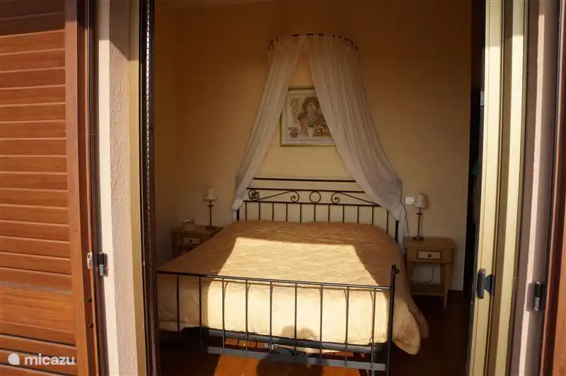 View of the bed from the balcony.