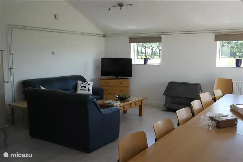 The sitting area in the living room, with gas fireplace and 3 and 2 seater sofa. The space will be repainted and furnished in the coming months.