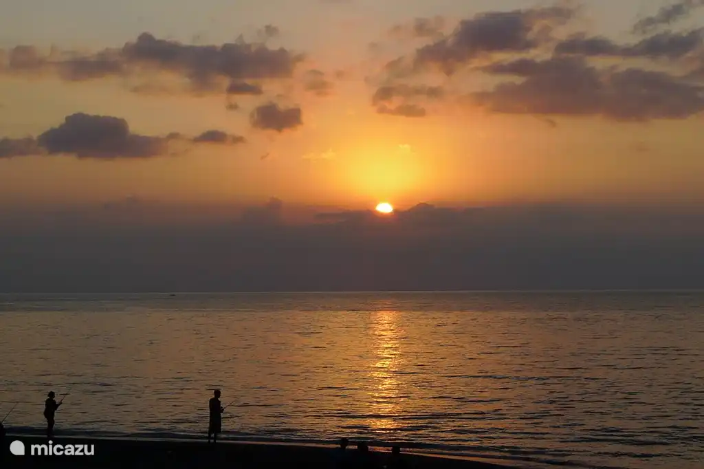 Fischer am Strand bei Sonnenuntergang