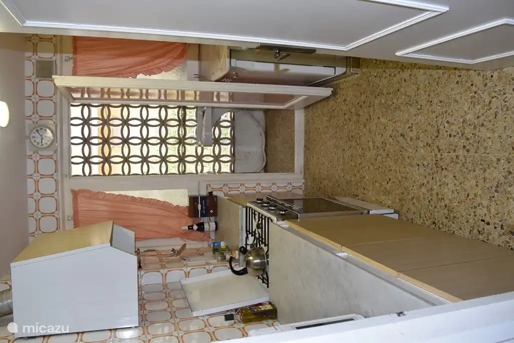 Cocina totalmente equipada, cocina a gas, horno, microondas, frigorífico, lavavajillas y lavadero con lavadora, tendedero y fregadero.