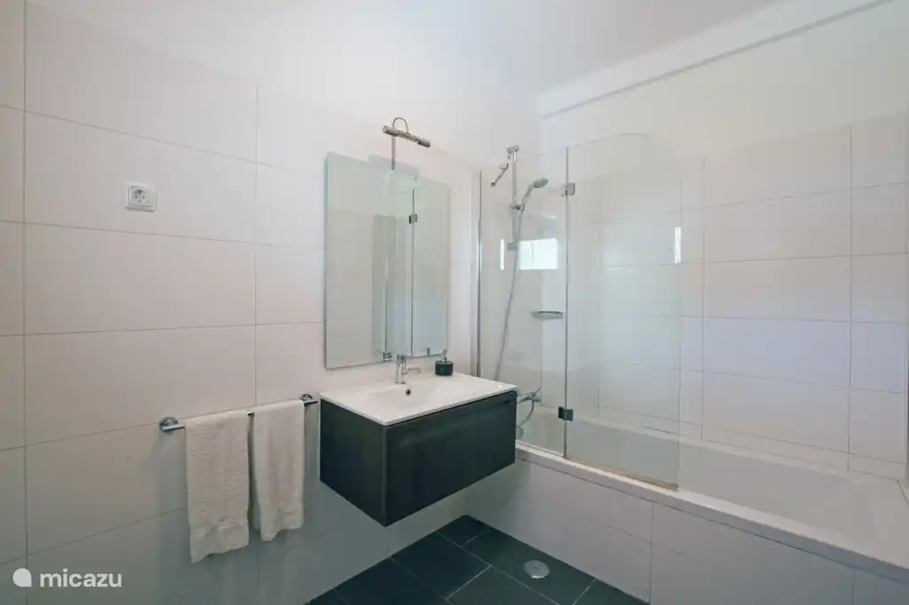 2 Badezimmer, neben Schlafzimmer 1. Das Badezimmer hat eine Badewanne mit Duschwand, WC und Waschbecken.