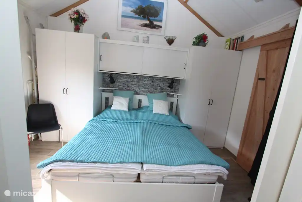 Une chambre double spacieuse avec deux placards suspendus / posés et un espace de rangement au-dessus du lit. Le lit dispose de 2 lits simples 80x200 cm.