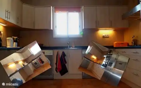 spacious main kitchen with modern appliances and refrigerator with ice maker