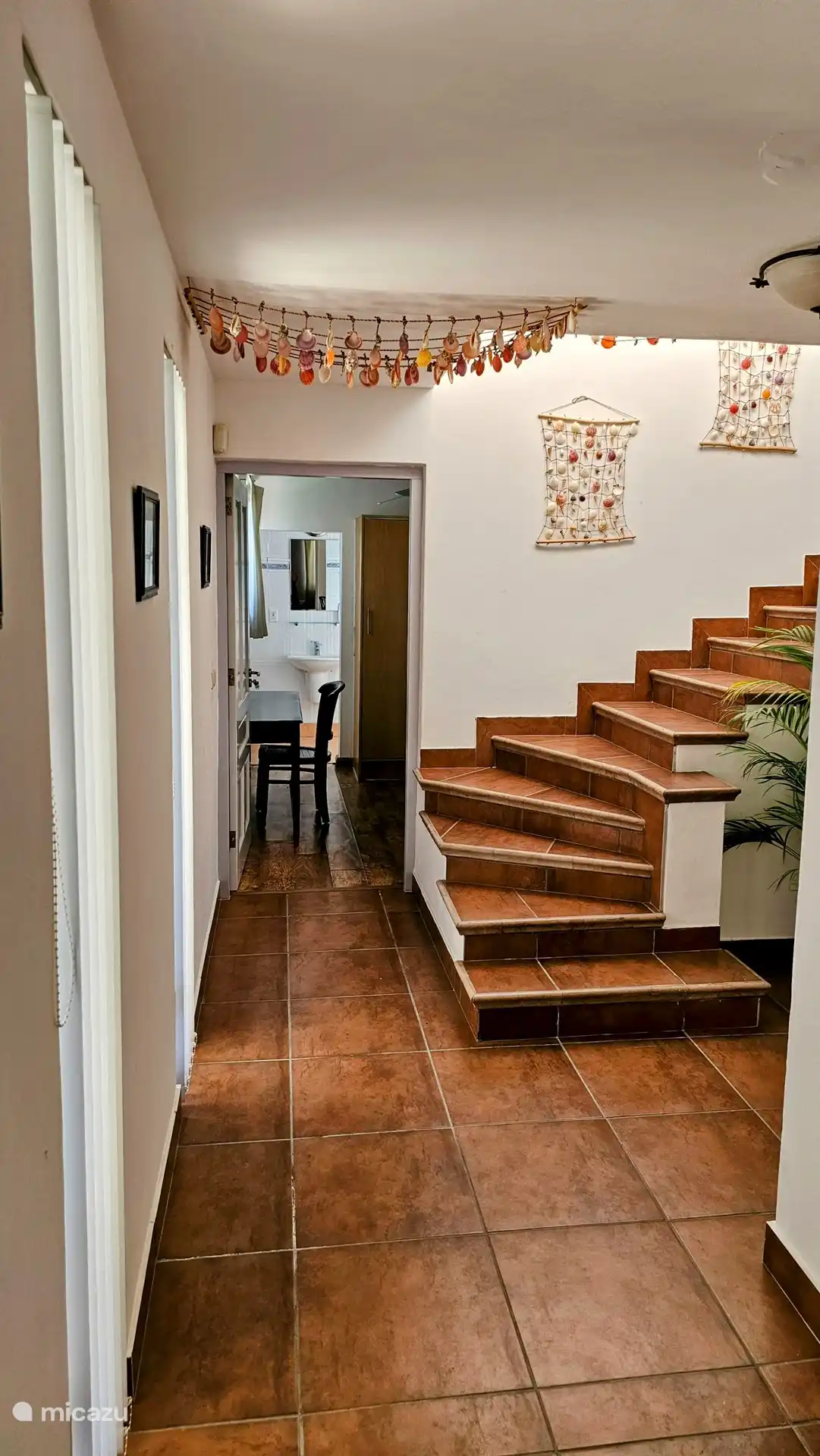 The stairs to the garage and the bedroom by the pool.