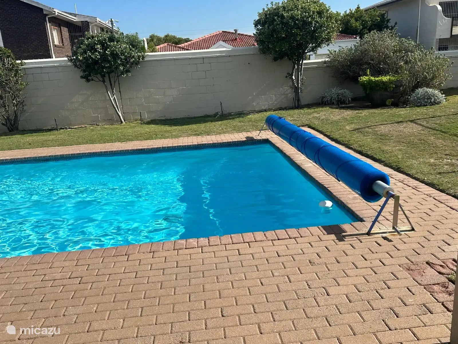 The swimming pool at the tennis court and the clubhouse on the secured park of Cayman Beach.