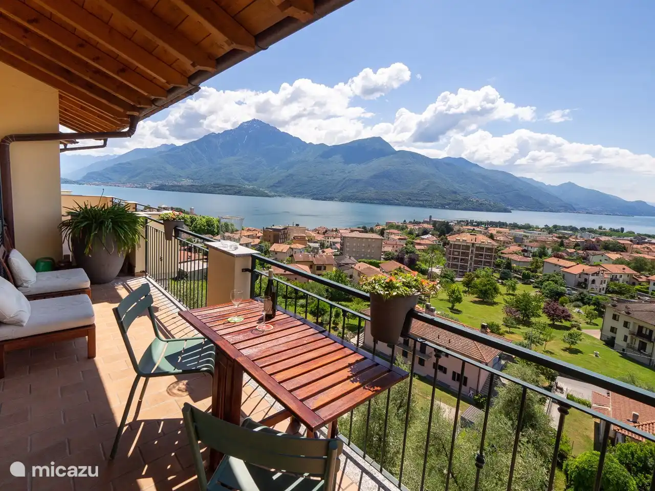 Ein weiterer Blick auf die Terrasse an der Vorderseite, mit den Bergen auf der anderen Seite des Sees. In dem großen Pflanzgefäß blüht im Sommer die Agapanthus (afrikanische Lilie). Es gibt auch einen beweglichen Sonnenschirm.