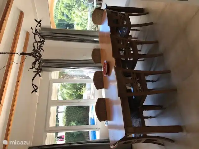 Dining room with view of swimming pool and covered terrace