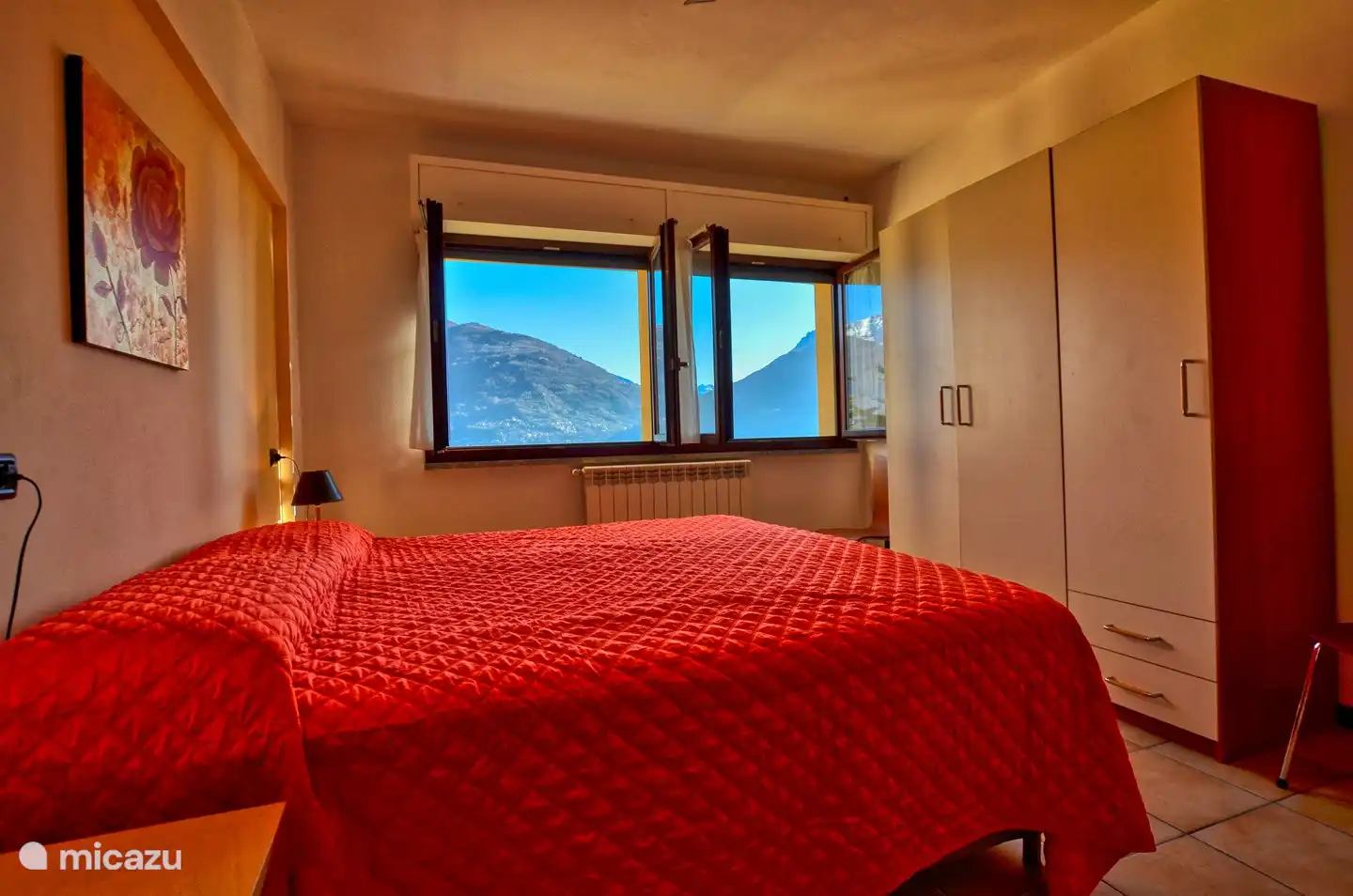 El dormitorio grande que incluye un amplio armario, ventilador de techo y con hermosas vistas a la montaña y al lago.