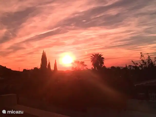 sunset by the swimming pool