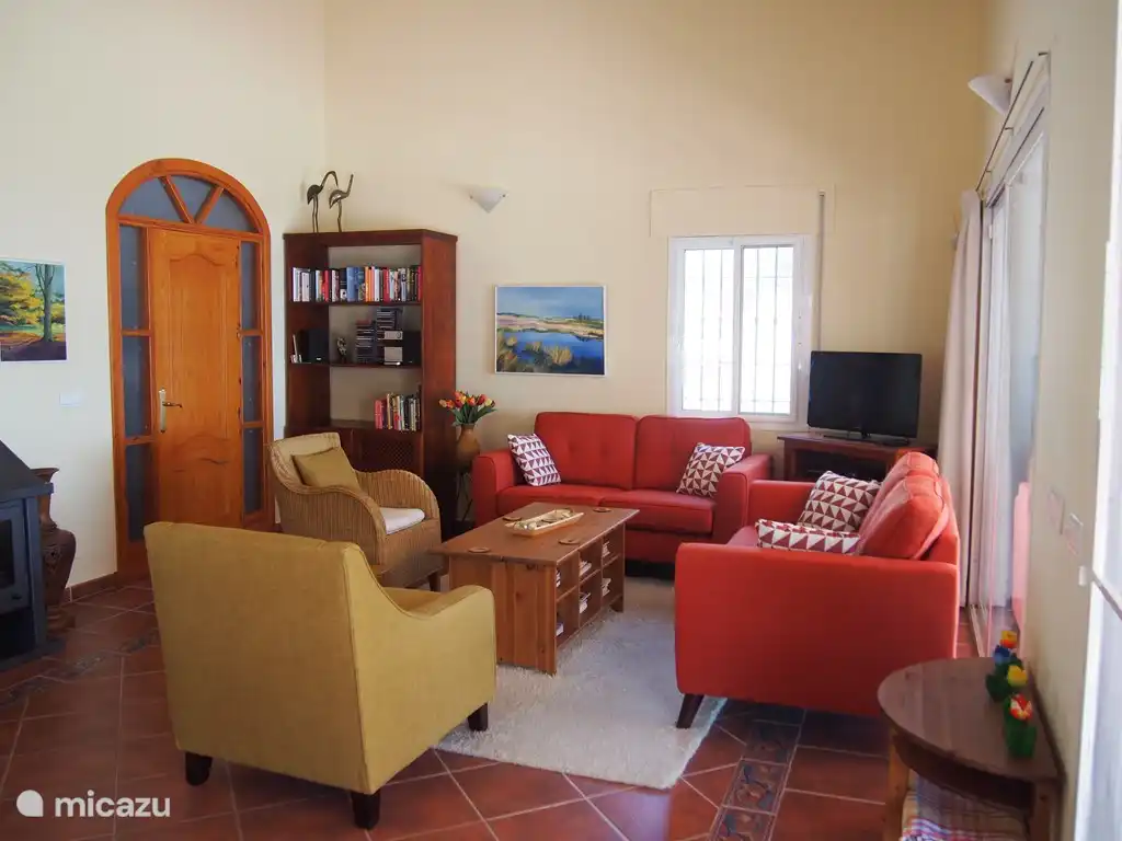 Coin salon séjour, avec la terrasse couverte derrière le canapé 2 places à droite