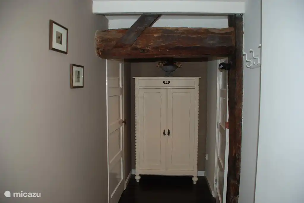 Hal 1: rechts naar slaapkamer 2, links naar hal 2. Het oude gebinte van de boerderij is in zicht.