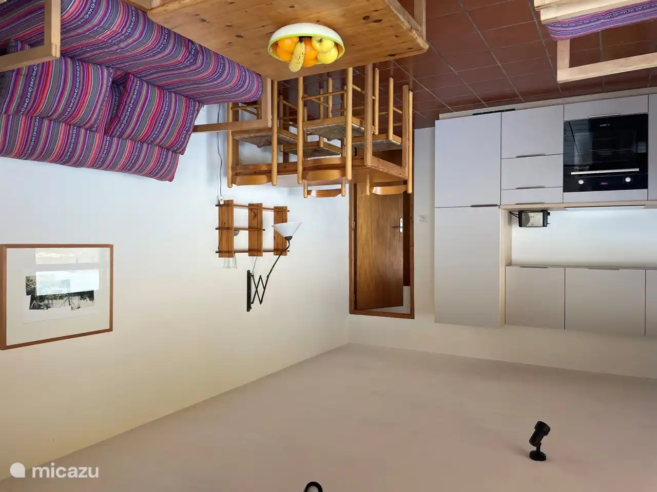 Living room with kitchen and door to bedroom