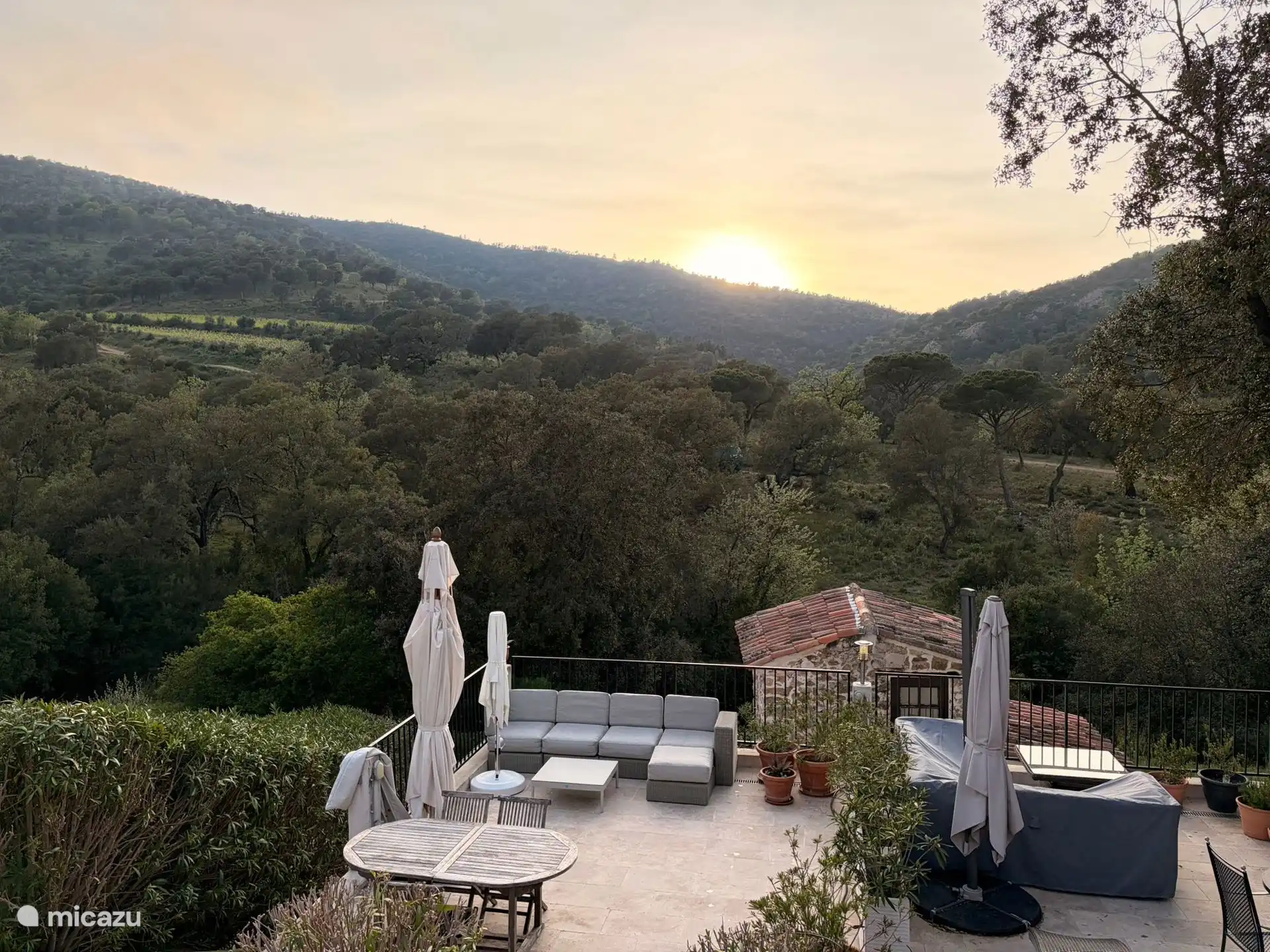 Privé terras met eettafel, loungebank, parasol en prachtig uitzicht