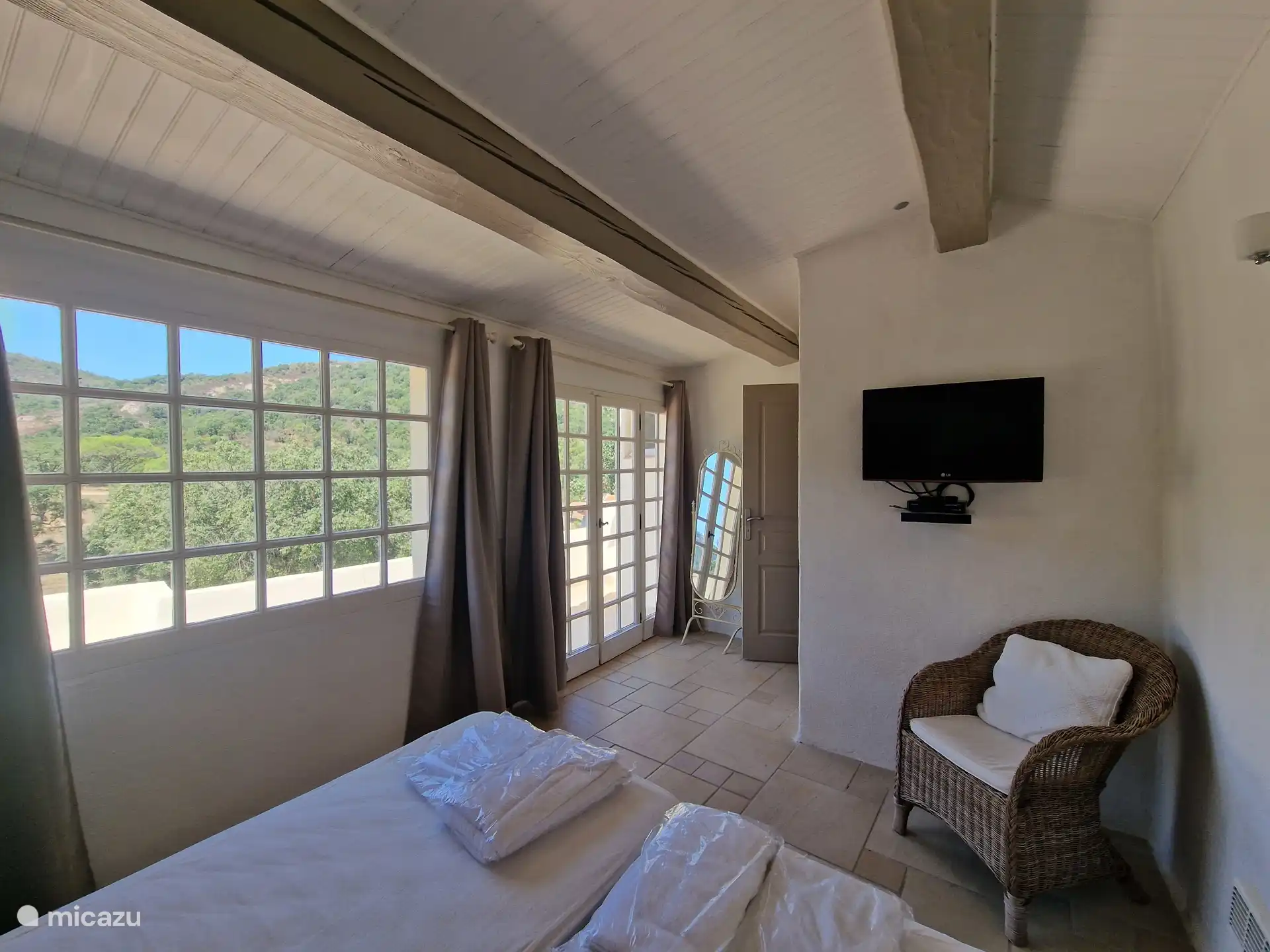 Double bedroom with TV and balcony