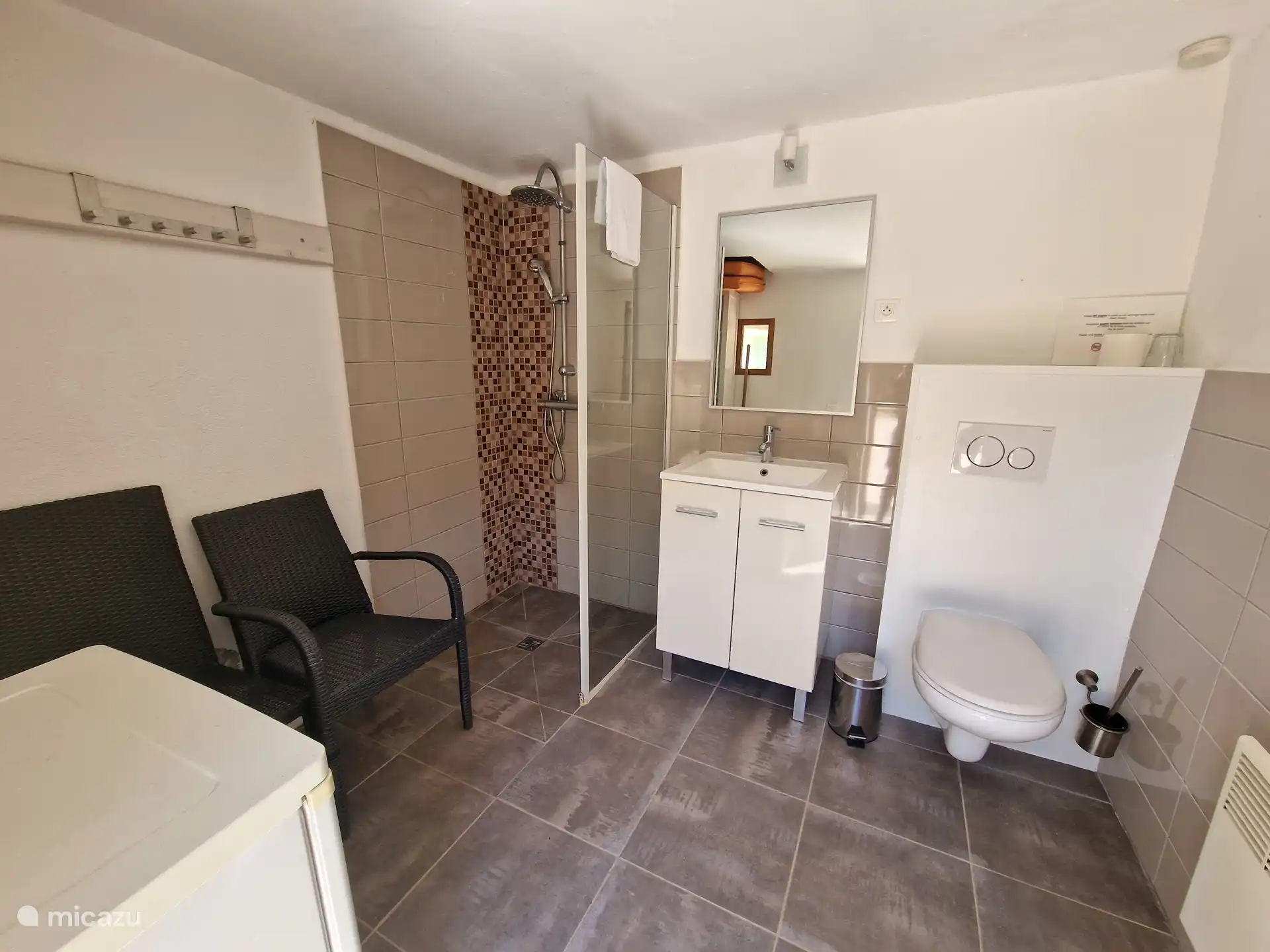 Bathroom in garden house with toilet, shower and sink
