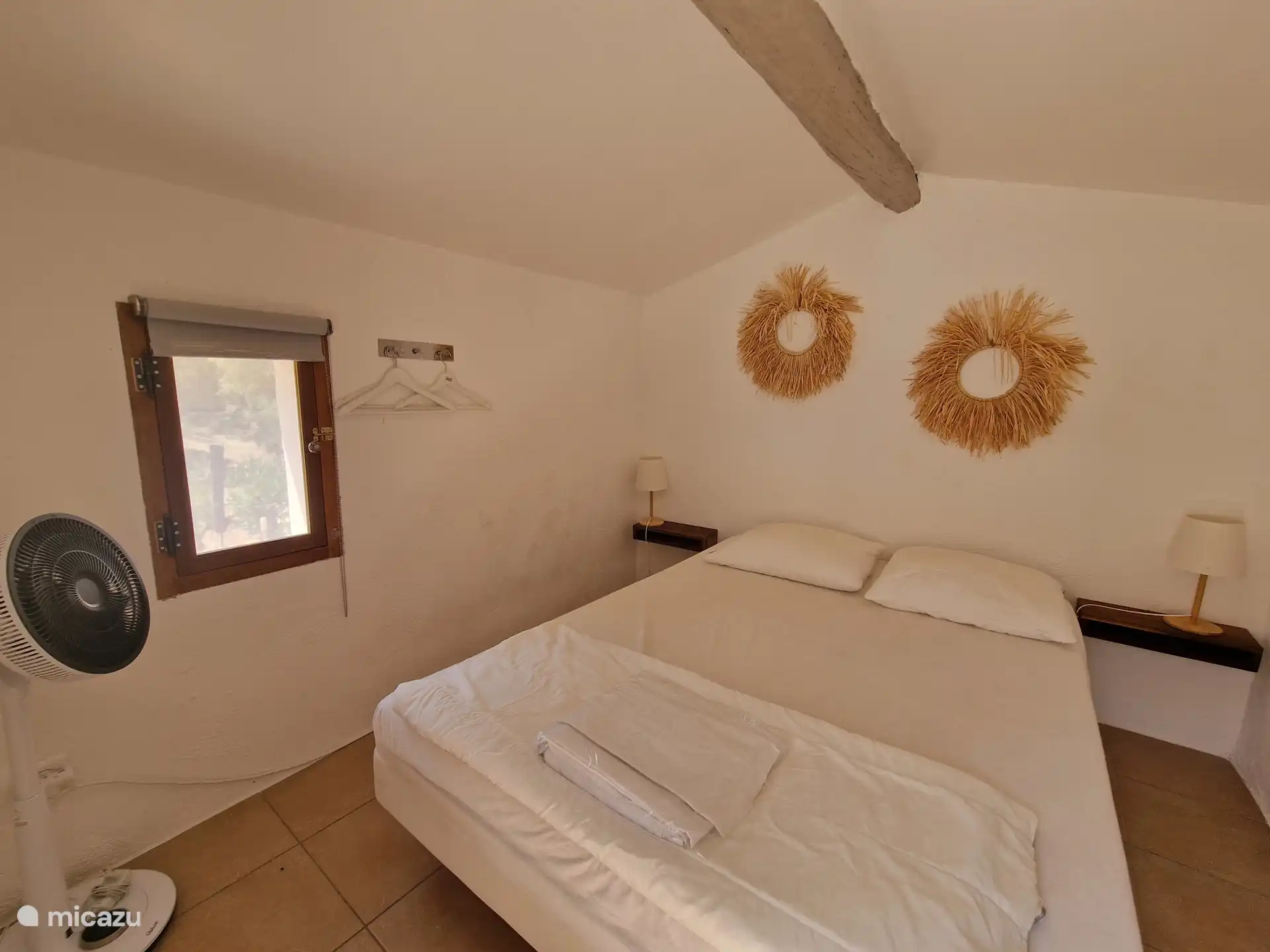 Bedroom in garden house with fan and mobile air conditioning