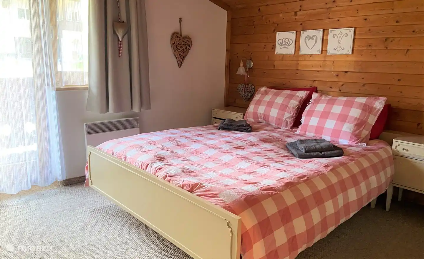 Delightful spacious bedroom with nice bed and adjoining large bathroom with tub and double sinks.