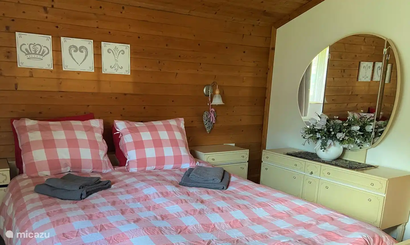 Spacious bedroom with closet space, mirror and adjoining bathroom with bath and two sinks