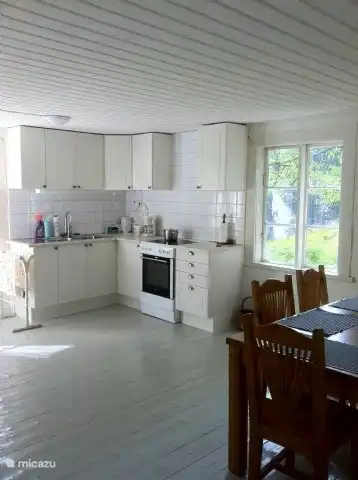 Spacious kitchen with large table.