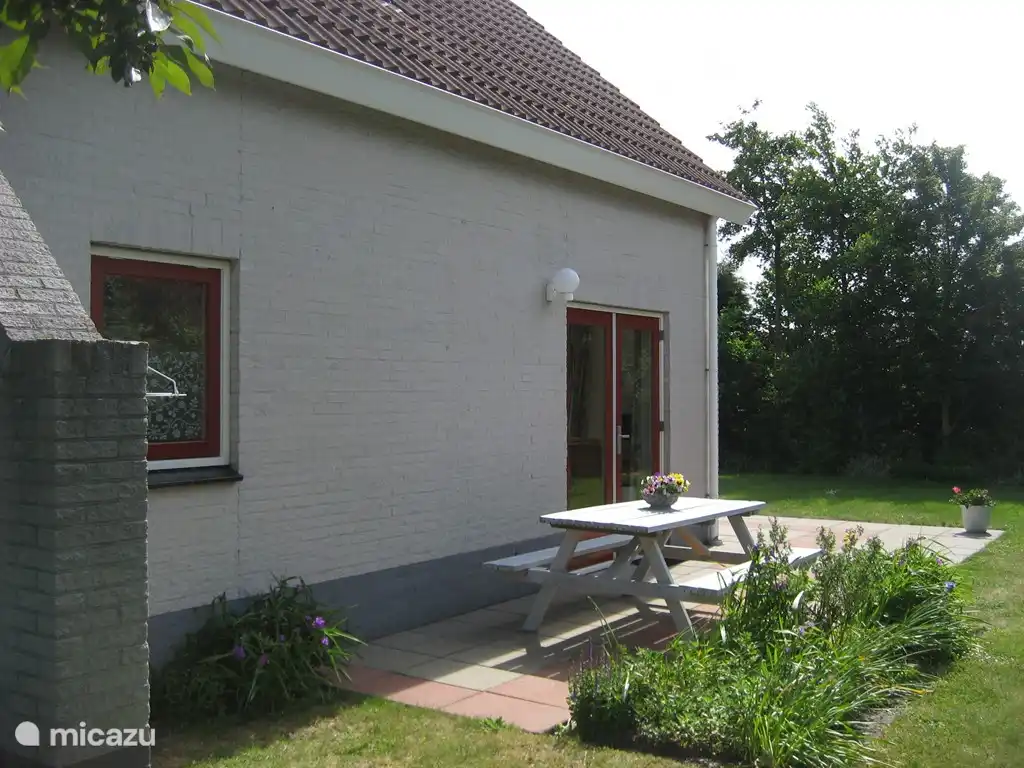 On the west side with picnic bench.