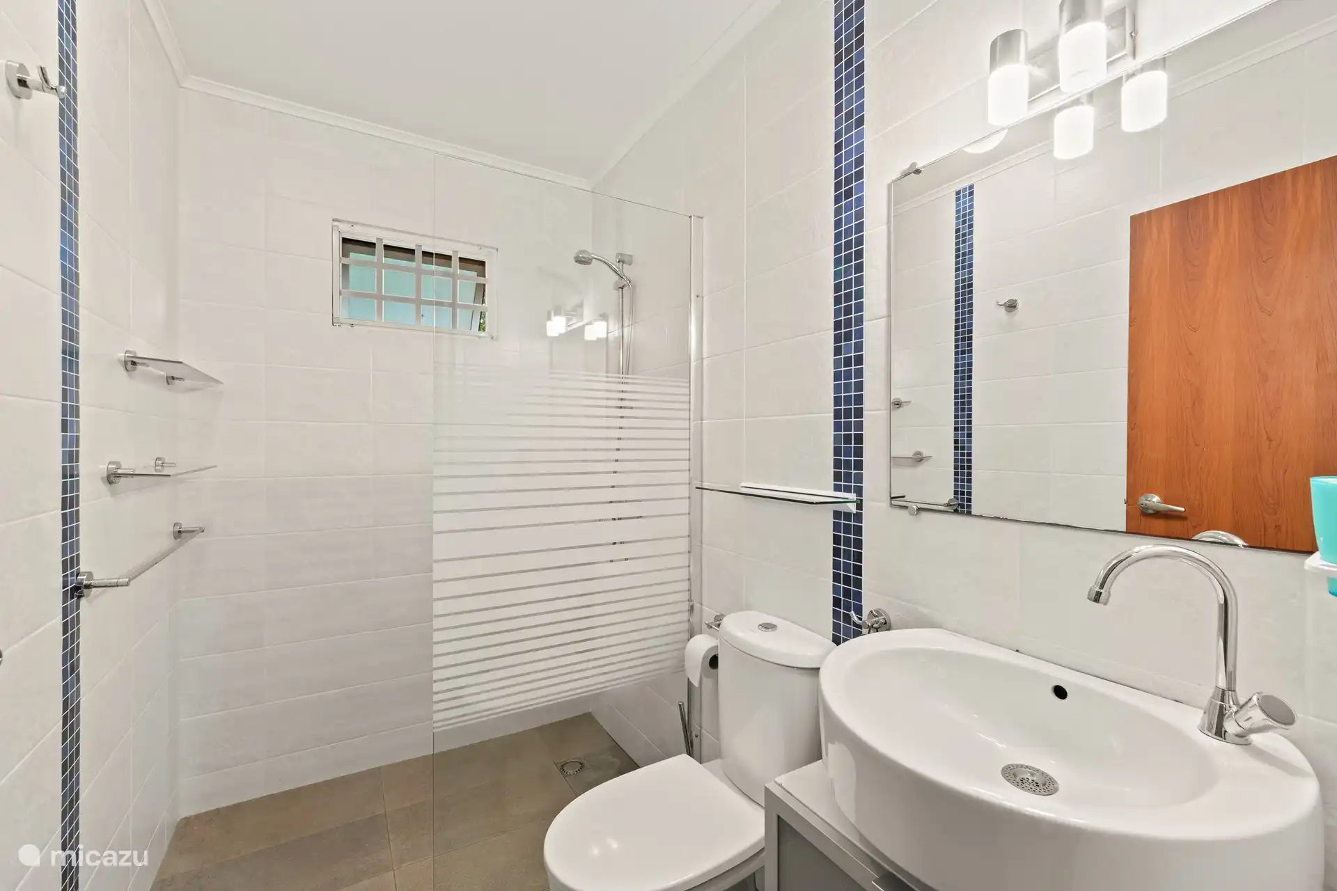 Bathroom 1 with spacious shower, sink and toilet
