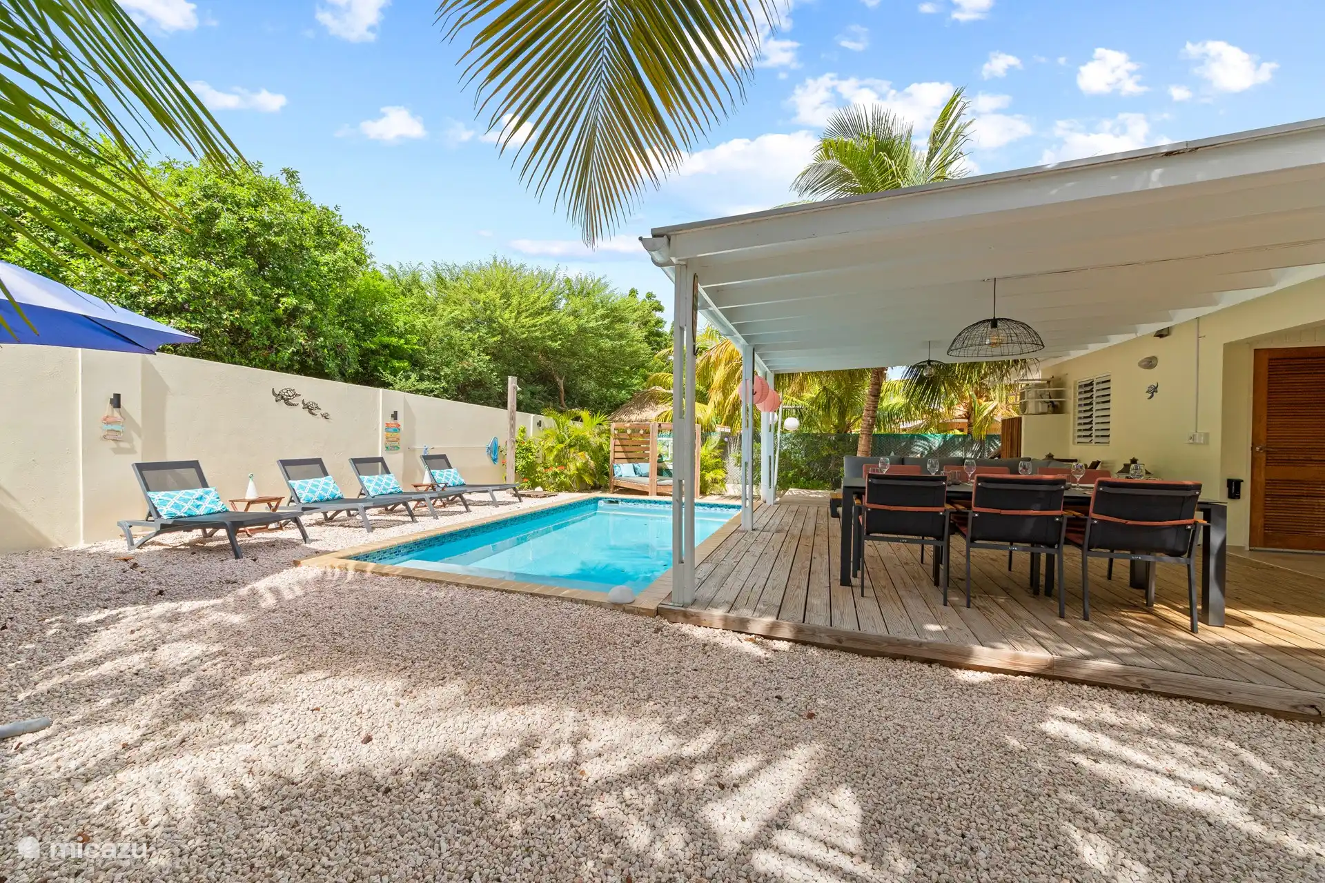 The pool deck has 1 lounge sofa and a dining area, both for 6 people