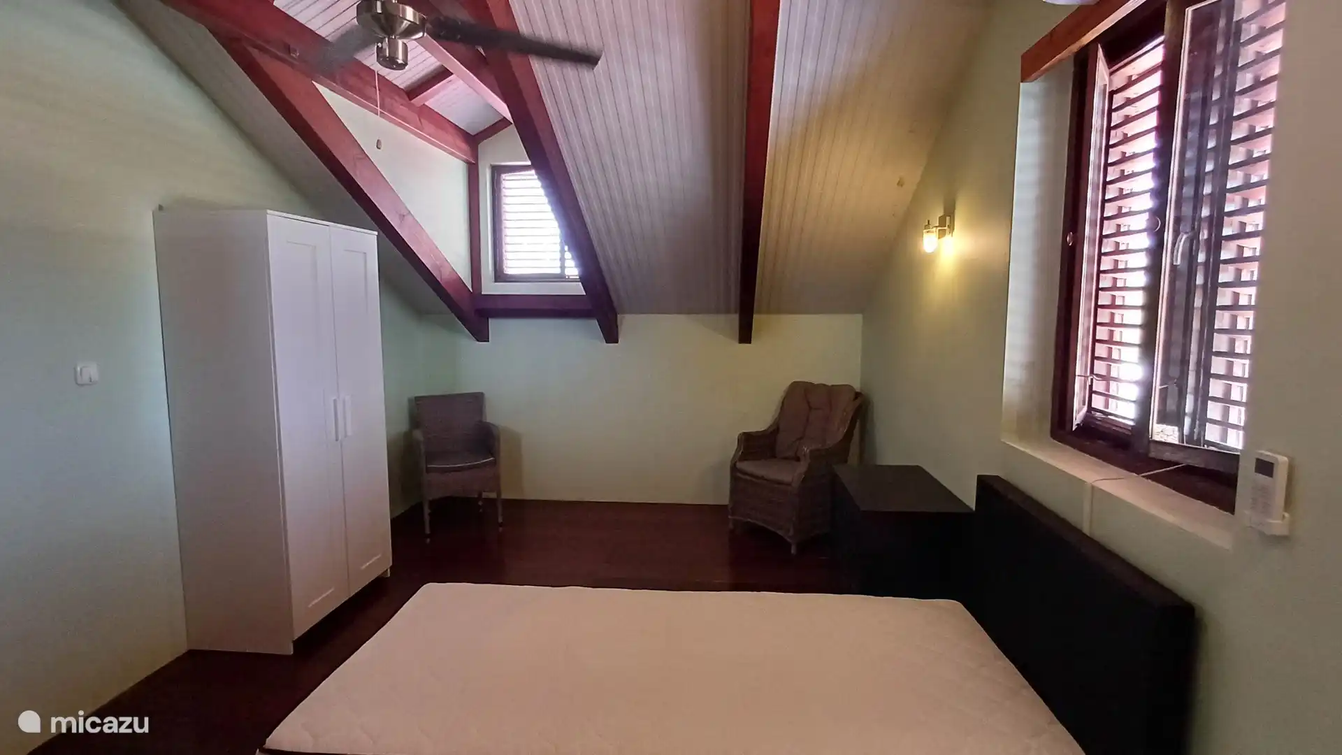 Attic room with air conditioning and ceiling fan